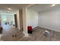 Spacious living room featuring newly installed flooring and fresh paint, creating a bright and inviting atmosphere at 18 W Emily Gardens Dr, Selma, NC 27576
