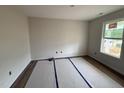 Bright bedroom with hardwood floors and a large window offering natural light at 18 W Emily Gardens Dr, Selma, NC 27577