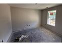 Spacious bedroom with freshly painted walls and bright natural light from a single window at 18 W Emily Gardens Dr, Selma, NC 27577