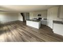 Open kitchen with stainless appliances, a large island, granite countertops, and hardwood floors at 18 W Emily Gardens Dr, Selma, NC 27576