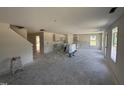 Open floor plan with kitchen featuring cabinets covered in plastic, new appliances and lots of light at 18 W Emily Gardens Dr, Selma, NC 27577