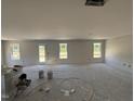 Bright living room showcasing newly painted walls, recessed lights, and a sliding glass door at 18 W Emily Gardens Dr, Selma, NC 27577