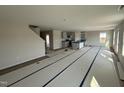 Spacious living room featuring an open layout, stairs, and a kitchen with modern finishes and abundant natural light at 18 W Emily Gardens Dr, Selma, NC 27577