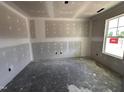 Unfinished room displaying drywall and a bright window at 18 W Emily Gardens Dr, Selma, NC 27577