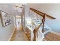 Bright foyer with hardwood floors, staircase with white railings and natural wood banister, and second story landing at 2011 Cross Bones Blvd # 41, Durham, NC 27703