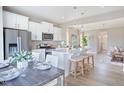 Bright kitchen with white cabinets, stainless appliances, modern lighting and a large island with seating for three at 2011 Cross Bones Blvd # 41, Durham, NC 27703