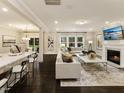 Bright, open living room with hardwood floors, a fireplace, and large windows at 205 E Fountainhead Ln # 159, Garner, NC 27529