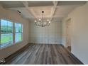 Elegant dining room featuring modern lighting, wainscoting and wood floors at 21 Trescott St, Smithfield, NC 27577