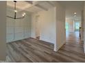 Elegant dining room featuring modern lighting, wainscoting and wood floors at 21 Trescott St, Smithfield, NC 27577