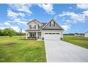 Inviting two-story home with a well-maintained lawn, perfect for outdoor enjoyment at 21 Trescott St, Smithfield, NC 27577