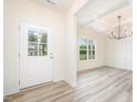 Welcoming entryway with hardwood flooring, chandelier and natural light streaming through window at 21 Trescott St, Smithfield, NC 27577