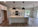 Modern kitchen with white cabinetry, granite countertops, stainless steel appliances, and pendant lighting at 21 Trescott St, Smithfield, NC 27577