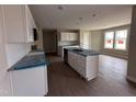 Well-lit kitchen with an island, white cabinets, and stainless steel appliances, ready for culinary adventures at 210 Maxwell Farm Ln, Selma, NC 27576
