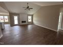 Bright, open-concept living room with vaulted ceiling, wood floors, fireplace, and plenty of natural light at 210 Maxwell Farm Ln, Selma, NC 27576