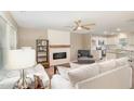 Inviting living room featuring hardwood floors, a modern fireplace, and comfortable neutral-toned furniture at 212 Tuscany Cir, Princeton, NC 27569