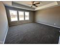 Expansive main bedroom featuring plush carpet, neutral paint, and natural light from large windows at 212 Tuscany Cir, Princeton, NC 27569