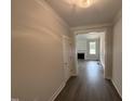 Inviting home entryway with elegant flooring leads to a cozy living room with a fireplace at 221 Tee Dr, Selma, NC 27576