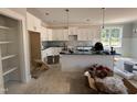 Open kitchen featuring a center island, stainless steel appliances, and white cabinets at 221 Tee Dr, Selma, NC 27576