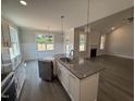 Modern kitchen with granite countertops, stainless steel appliances, and a center island at 221 Tee Dr, Selma, NC 27576
