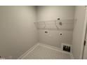 Spacious laundry room with tile flooring and ample storage space at 221 Tee Dr, Selma, NC 27576