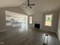 Open-concept living room with fireplace, and views to the kitchen and dining areas at 221 Tee Dr, Selma, NC 27576
