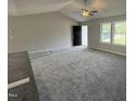 Bright living room with plush gray carpet and a ceiling fan at 225 Phil Jack Rd, Dunn, NC 28334