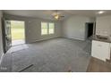Bright living room with plush gray carpet and a ceiling fan at 225 Phil Jack Rd, Dunn, NC 28334