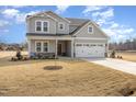 Well-maintained two-story home with attached two-car garage and a wide concrete driveway at 231 Trescott St, Smithfield, NC 27577