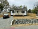 Charming cottage-style home with a cozy front porch, fresh landscaping, and a newly graveled driveway at 2316 Radiance Dr, Burlington, NC 27215