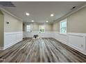 Spacious living room with fresh paint, white wainscoting, hardwood floors, and ample natural light at 2316 Radiance Dr, Burlington, NC 27215