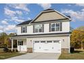 Inviting two-story home featuring a prominent garage and classic architectural details at 246 Trescott St, Smithfield, NC 27577