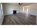 Spacious living room featuring a fireplace, ceiling fan, wood floors, and neutral paint at 253 Trescott St, Smithfield, NC 27577
