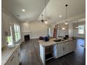 Modern kitchen featuring granite countertops, white cabinetry, and an open layout to the living room at 28 Bailey-Boykin Rd, Selma, NC 27576