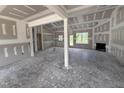 Bright living room under construction with fireplace, large windows and open floorplan at 28 Bailey-Boykin Rd, Selma, NC 27576