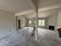 Spacious living room featuring ample natural light, fireplace, and neutral walls at 28 Bailey-Boykin Rd, Selma, NC 27576