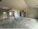 Open-concept living area with great natural light featuring neutral walls and smooth concrete flooring at 28 Bailey-Boykin Rd, Selma, NC 27576