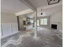 Spacious living room with fireplace and wainscoting that flows into a kitchen with an island at 28 Bailey-Boykin Rd, Selma, NC 27576