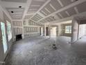 Large living room under construction featuring fireplace, large windows, and high ceilings at 28 Bailey-Boykin Rd, Selma, NC 27576
