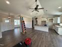 Open-concept living space with hardwood floors, ceiling fan, and modern lighting fixtures at 28 Bailey-Boykin Rd, Selma, NC 27576