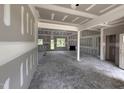 Living room under construction features fireplace, large windows, and open floorplan at 28 Bailey-Boykin Rd, Selma, NC 27576