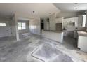 Open-concept living space featuring a kitchen island, white cabinets, and paneled walls at 28 Bailey-Boykin Rd, Selma, NC 27576