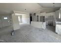 Unfinished living room with an open floor plan to the kitchen featuring white cabinets at 28 Bailey-Boykin Rd, Selma, NC 27576