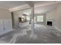 Bright open-concept living space with a fireplace, kitchen island, and ample natural light at 28 Bailey-Boykin Rd, Selma, NC 27576