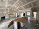 Unfinished living room boasts a modern fireplace, white cabinets and an open design ready for customization at 28 Bailey-Boykin Rd, Selma, NC 27576
