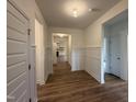 Inviting entryway featuring wood-look floors and decorative wainscoting leading into the home at 282 Trescott St, Smithfield, NC 27577