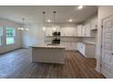 Bright kitchen with stainless steel appliances, a granite island, and ample cabinet space at 282 Trescott St, Smithfield, NC 27577