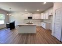 Bright kitchen with an island, granite countertops, stainless steel appliances, and ample cabinet space at 282 Trescott St, Smithfield, NC 27577