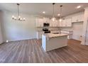 Modern kitchen featuring granite countertops, stainless steel appliances, a large island, and ample cabinet space at 282 Trescott St, Smithfield, NC 27577
