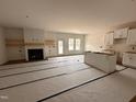 Open concept living room with fireplace, wood floors, natural light, and open to kitchen at 282 Trescott St, Smithfield, NC 27577