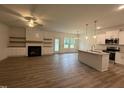 Open-concept living room and kitchen boast a fireplace, kitchen island, and modern finishes at 282 Trescott St, Smithfield, NC 27577